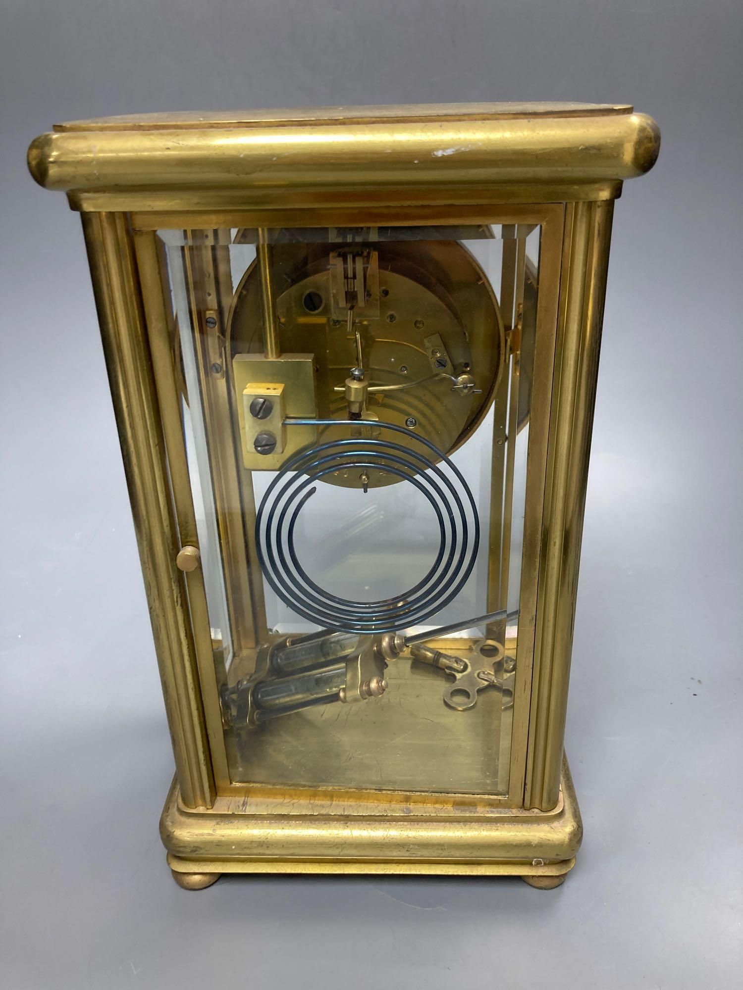 A four glass and brass mantel clock with mercury pendulum, 18cm high, 17cm wide,13cm deep